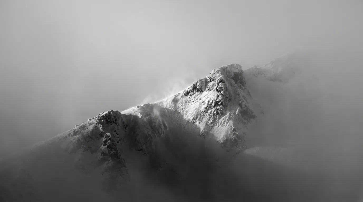 Snowy mountain ridge in fog 20260914121538
